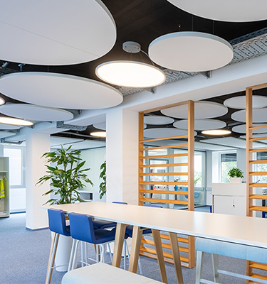 Deckenleuchten und runde Schallschutz-Absorber im Büro